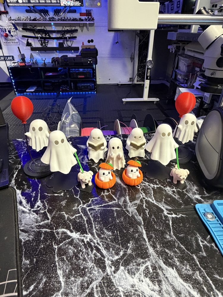 A lineup of ghost figures with balloons and pumpkin pails