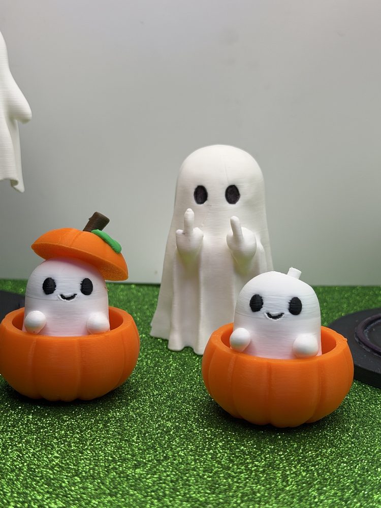 Cute ghosts sitting in pumpkins with a middle-finger ghost
